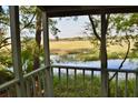 Serene porch view of a marsh, complete with lush greenery, and a glimpse of open sky at 642 Harbor Creek Pl # 21, Charleston, SC 29412