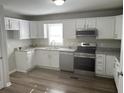 Bright kitchen features granite countertops, stainless steel appliances, and white cabinets at 732 Gahagan Rd, Summerville, SC 29485