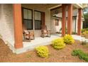 Inviting front porch featuring classic rocking chairs and decorative landscaping that offers curb appeal at 74 Longleaf Dr, Walterboro, SC 29488