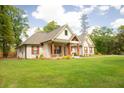 Charming single-story home featuring a beautifully landscaped front yard, and craftsman style covered front porch at 74 Longleaf Dr, Walterboro, SC 29488