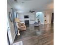 Inviting living room featuring a fireplace, built-in shelving and dark hardwood floors at 7406 Purser Ln, Hanahan, SC 29410