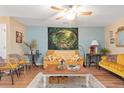 Bright living room with ceiling fan and tapestry offering a cozy gathering space at 7873 Park Gate Dr, North Charleston, SC 29418