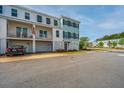 Charming townhome exterior featuring stacked balconies, covered garages, and lovely landscaping at 806 Kings Oak Court Ct # 7, Charleston, SC 29492