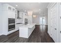 Bright kitchen with stainless steel appliances, pendant lighting and a large island at 806 Kings Oak Court Ct # 7, Charleston, SC 29492