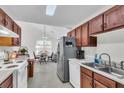 Well-lit eat-in kitchen featuring stainless steel appliances and cherry wood cabinets under a skylight at 8219 Quail Hollow Ct, North Charleston, SC 29420