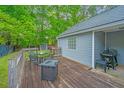Outdoor wooden deck featuring patio furniture, a barbecue grill, and an outdoor fireplace at 9156 Fieldstone Trce, Summerville, SC 29485