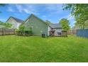 A spacious backyard with green grass and a wooden fence surrounding the perimeter at 9156 Fieldstone Trce, Summerville, SC 29485