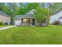 Charming single-story home with a well-manicured lawn, flowering bushes and an attached garage at 9156 Fieldstone Trce, Summerville, SC 29485
