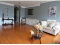 Bright living room features hardwood floors, neutral decor, and elegant furnishings at 9163 Parlor Dr, Ladson, SC 29456