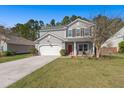 Attractive two-story house with gray siding, a well-manicured lawn, and an attached garage at 1019 Victoria Pointe Ln, Summerville, SC 29485