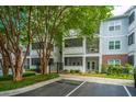 Attractive condo building with screened porches, and parking, surrounded by mature trees and greenery at 1025 Riverland Woods Pl # 901, Charleston, SC 29412