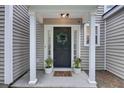 Charming home exterior showcasing a covered front porch, stylish front door, and manicured landscaping at 1027 Island View Ct, Charleston, SC 29492