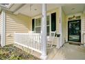 Inviting front porch with rocking chairs and a view of the home's entrance at 108 Gaslight Blvd, Summerville, SC 29483