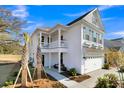 Beautiful two-story home features a side porch, two-car garage, and manicured landscaping, all beneath a clear blue sky at 108 O'Leary Cir, Summerville, SC 29483