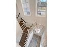 Bright foyer showcasing a modern chandelier, staircase with dark wood treads, and plenty of natural light at 108 O'Leary Cir, Summerville, SC 29483