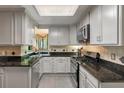 Well-lit kitchen features granite countertops, stainless steel appliances, and tiled backsplash at 111 Garden Hill Rd, Summerville, SC 29483