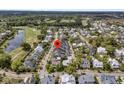 Serene aerial view of a residential community with lush greenery, a golf course, and a lake at 112 Brailsford St, Charleston, SC 29492