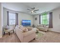 Cozy living room with ample seating, ceiling fan, and lots of natural light at 134 Stoney Creek Way, Moncks Corner, SC 29461