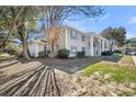 Condominium exterior showcasing mature trees, green lawn, and classic architectural details at 1402 Camp Rd # 8B, Charleston, SC 29412