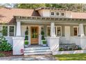 Charming front porch with decoratively potted shrubbery and rocking chairs, showcasing the entryway to the house at 1454 Seminole St, Mount Pleasant, SC 29464