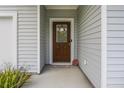 A welcoming front porch features a rustic wood door and a cozy 'Welcome Home' doormat at 1513 Thin Pine Dr, Johns Island, SC 29455