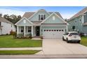 Inviting two-story home with a well-maintained lawn and a convenient two-car garage at 154 Boots Branch Rd, Summerville, SC 29485