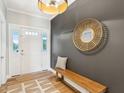Bright entryway featuring hardwood floors, decorative mirror, coat hooks, and ample natural light at 1614 Teal Marsh Rd, Charleston, SC 29412