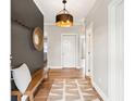 Inviting foyer with hardwood floors, stylish lighting, and a decorative mirror at 1614 Teal Marsh Rd, Charleston, SC 29412