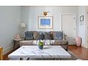 Comfortable living room showcasing a leather sofa, marble coffee table, and charming decor at 162 Spring St # A, Charleston, SC 29403