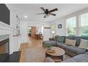 Bright, open living room with a decorative fireplace, hardwood floors, and plenty of natural light at 1637 Pinckney Park Dr, Charleston, SC 29407