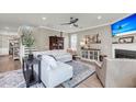 Comfortable living room featuring a stylish sectional sofa, fireplace, and modern ceiling fan at 1814 Grovehurst Dr, Charleston, SC 29414