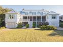 Beautiful home with a garage, lots of green space, and an outdoor living area above at 2114 Pettigrew St, Sullivans Island, SC 29482