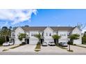 Beautiful townhomes feature single-car garages, dark front doors, manicured lawns, and landscaping at 2308 Watchtower Ln, Charleston, SC 29414