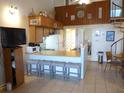 Cozy kitchen featuring a breakfast bar with seating, spiral staircase, and beach-themed decor at 237 Driftwood Ln, Edisto Island, SC 29438