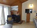 Comfortable living room with a fireplace and adjacent breakfast bar at 237 Driftwood Ln, Edisto Island, SC 29438