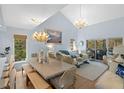 Bright living room with vaulted ceilings, beachy decor, and sliding glass doors at 2401 Racquet Club Dr, Seabrook Island, SC 29455