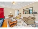 Cozy living room featuring a red door, comfortable armchairs, and stylish rug, creating a warm and inviting atmosphere at 32 Rosedale Dr, Charleston, SC 29407