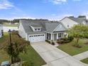 Charming home with a two-car garage, and well-maintained landscaping in a desirable community at 321 Sanctuary Park Dr, Summerville, SC 29486