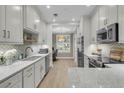 Modern kitchen with white cabinetry, marble countertops, and stainless steel appliances at 3372 Billings St, Mount Pleasant, SC 29466