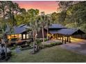 Beautiful home with lush landscaping, a covered carport, and an elegant water fountain at 3610 Legareville Rd, Johns Island, SC 29455