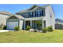 Lovely two-story home with a two-car garage and green lawn, perfect for Gathering living at 362 Lake Ridge Blvd, Summerville, SC 29486