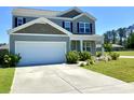 Attractive two-story home with a two-car garage and well-kept lawn, offering great curb appeal at 362 Lake Ridge Blvd, Summerville, SC 29486