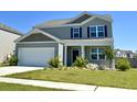 Well-maintained two-story house with neat landscaping, green lawn, and a two-car garage at 362 Lake Ridge Blvd, Summerville, SC 29486
