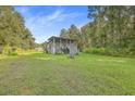 Charming home featuring a lush lawn and a classic exterior design nestled among mature trees at 364 Dupre Rd, McClellanville, SC 29458