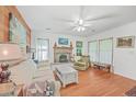 Cozy living room with wood floors, fireplace, and lots of light from the large windows at 364 Dupre Rd, McClellanville, SC 29458