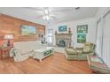 Comfortable living room featuring wood floors, fireplace with artwork, and lots of natural light at 364 Dupre Rd, McClellanville, SC 29458