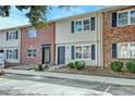 Charming townhome exterior with brick and siding facade and dark shutters at 415 Parkdale Dr # 12D, Charleston, SC 29414