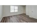 Bright living room with wood-look flooring and large window at 415 Parkdale Dr # 12D, Charleston, SC 29414