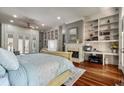 Spacious main bedroom with hardwood floors, a fireplace, built-in shelves, and backyard access at 421 Royal Assembly Dr, Charleston, SC 29492