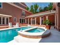 Inviting backyard pool and spa area surrounded by a patio and access to the home's veranda at 421 Royal Assembly Dr, Charleston, SC 29492